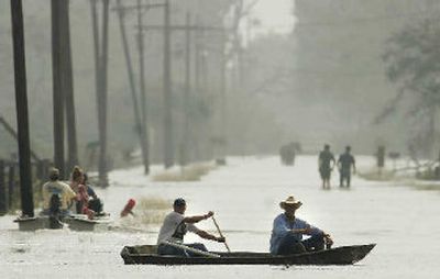 
Residents try to get to their homes by wading or boating through floodwaters in the wake of Hurricane Rita on Sunday morning in Carlyss, La.
 (Associated Press / The Spokesman-Review)