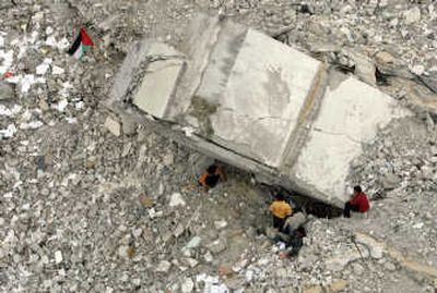 
Palestinians search Monday in the debris of a Gaza City building used by Hamas and destroyed by an Israeli missile strike in late February. Associated Press
 (Associated Press / The Spokesman-Review)