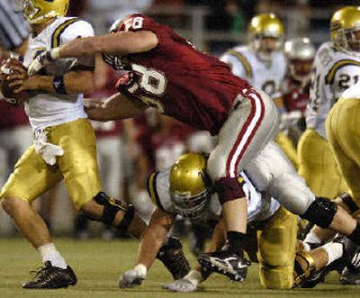 
Defensive end Matt Mullennix uses strength to rush passer. 
 (Christopher Anderson / The Spokesman-Review)
