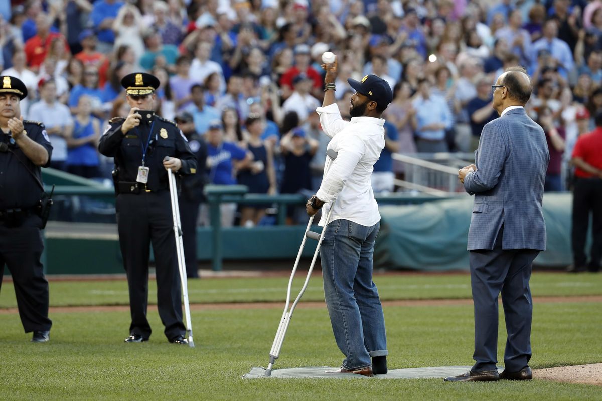 Injured Capitol Hill Police officer David Bailey throws out a ceremonial first pitch with Joe Torre, MLB