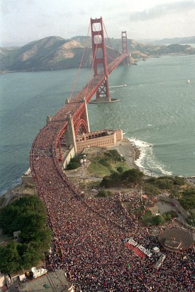 Above: On May 24, 1987, crowds jammed the Golden Gate to celebrate the 50th anniversary of the bridge. Right: Military biplanes fly between the towers as pedestrians walk across the span during opening ceremonies on May 27, 1937.