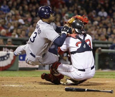 Carl Crawford is out, but he gets in the best shot as he drills Red Sox catcher Jason Varitek as Crawford tries to score in eighth inning.  (Associated Press / The Spokesman-Review)