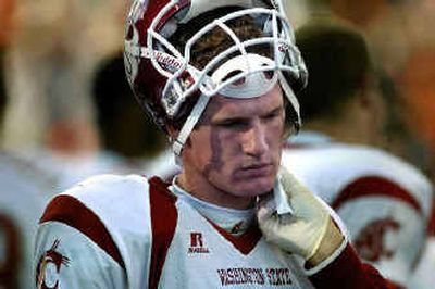 
WSU quarterback Alex Brink gets a small cut on his face attended to on the sideline.
 (Christopher Anderson/ / The Spokesman-Review)