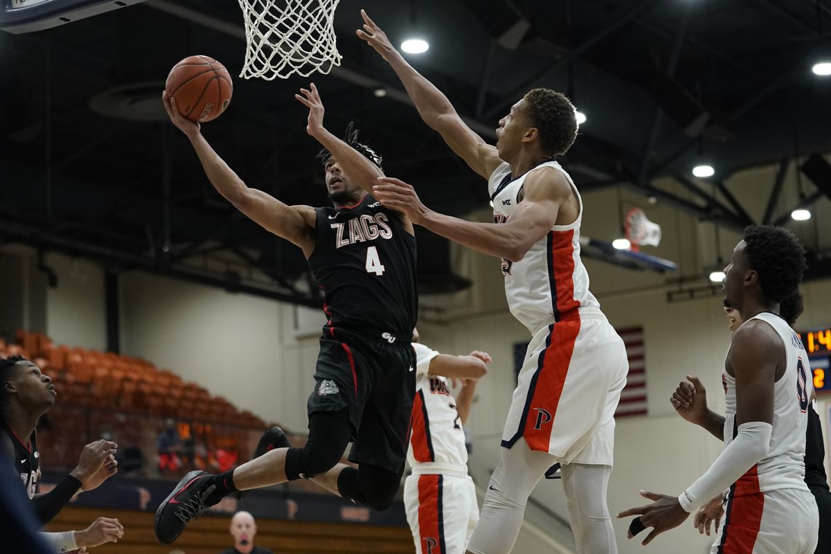 Gonzaga’s Aaron Cook, shooting against Pepperdine’s Kessler Edwards, got the offense going Saturday after the Bulldogs’ slow start.  (Associated Press)