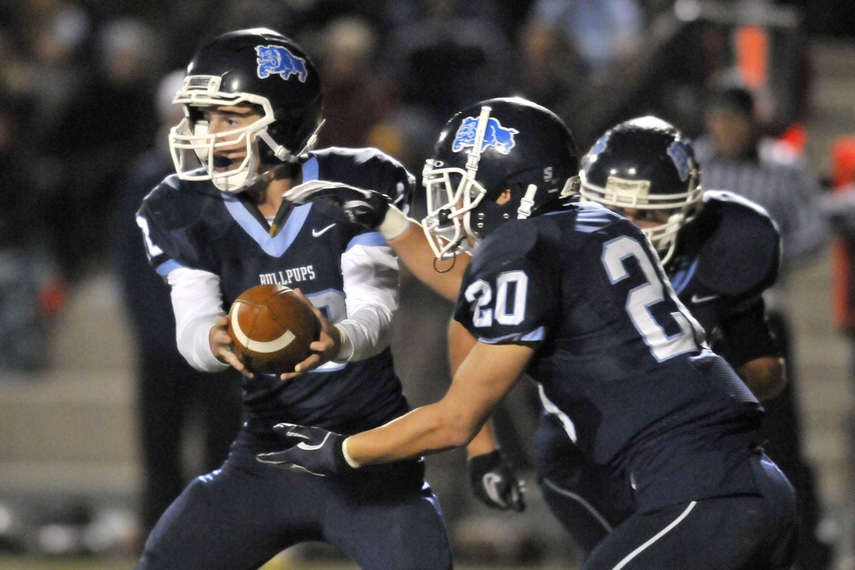 Gonzaga Prep QB Zach Bonneau, left, hands off to running back Griffin Hare. (Jesse Tinsley)