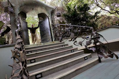 
Karl Johnson stands at the mammoth gate he created from welded scrap steel. It serves as the entry to a sunken garden retreat at the Beerses' home. 
 (Los Angles Times / The Spokesman-Review)