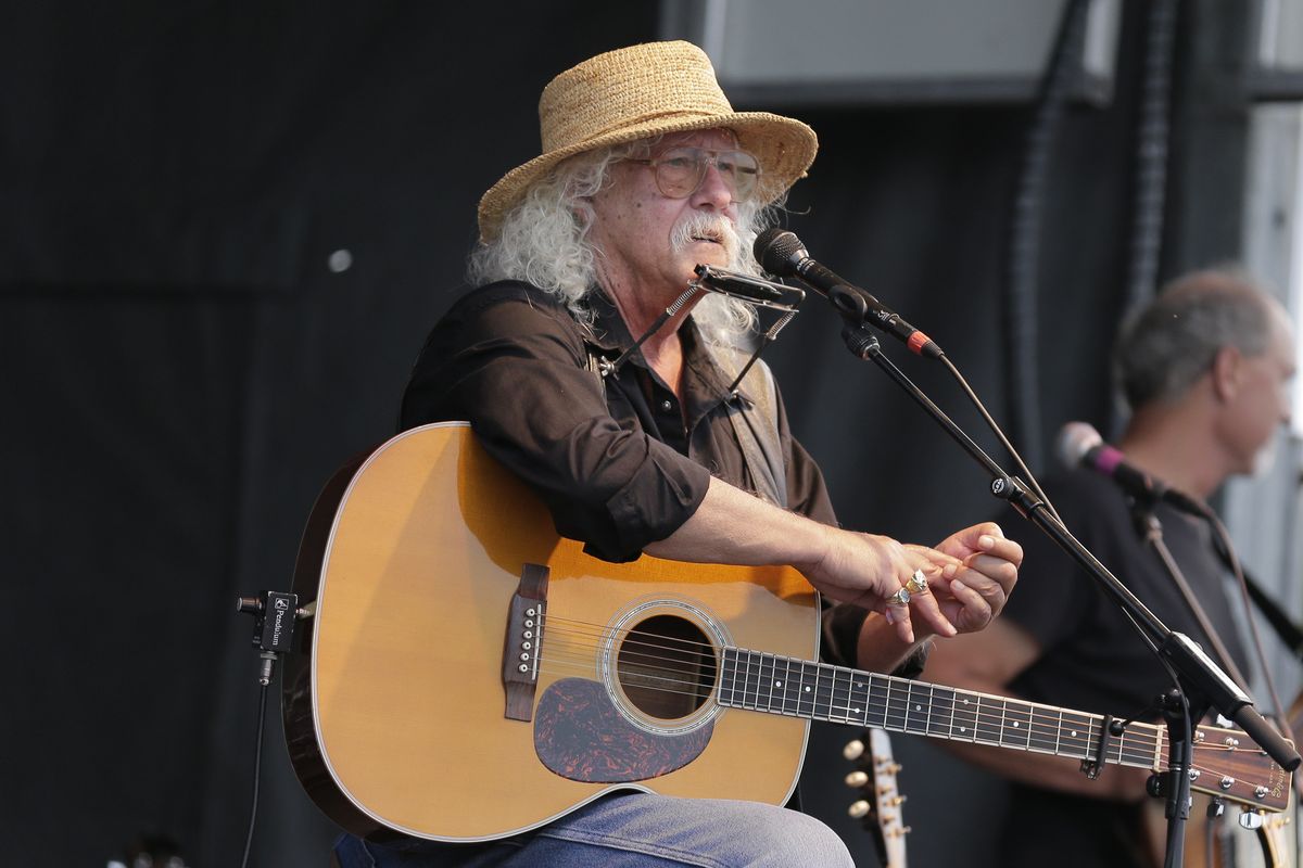 FILE - In this Aug. 15, 2020 file photo Arlo Guthrie talks during a concert at a Woodstock 50th anniversary event in Bethel, N.Y.In lengthy posts on his Facebook page and website, the 73-year-old folksinger announced Friday, Oct. 23, 2020, he is retiring from performance immediately. He