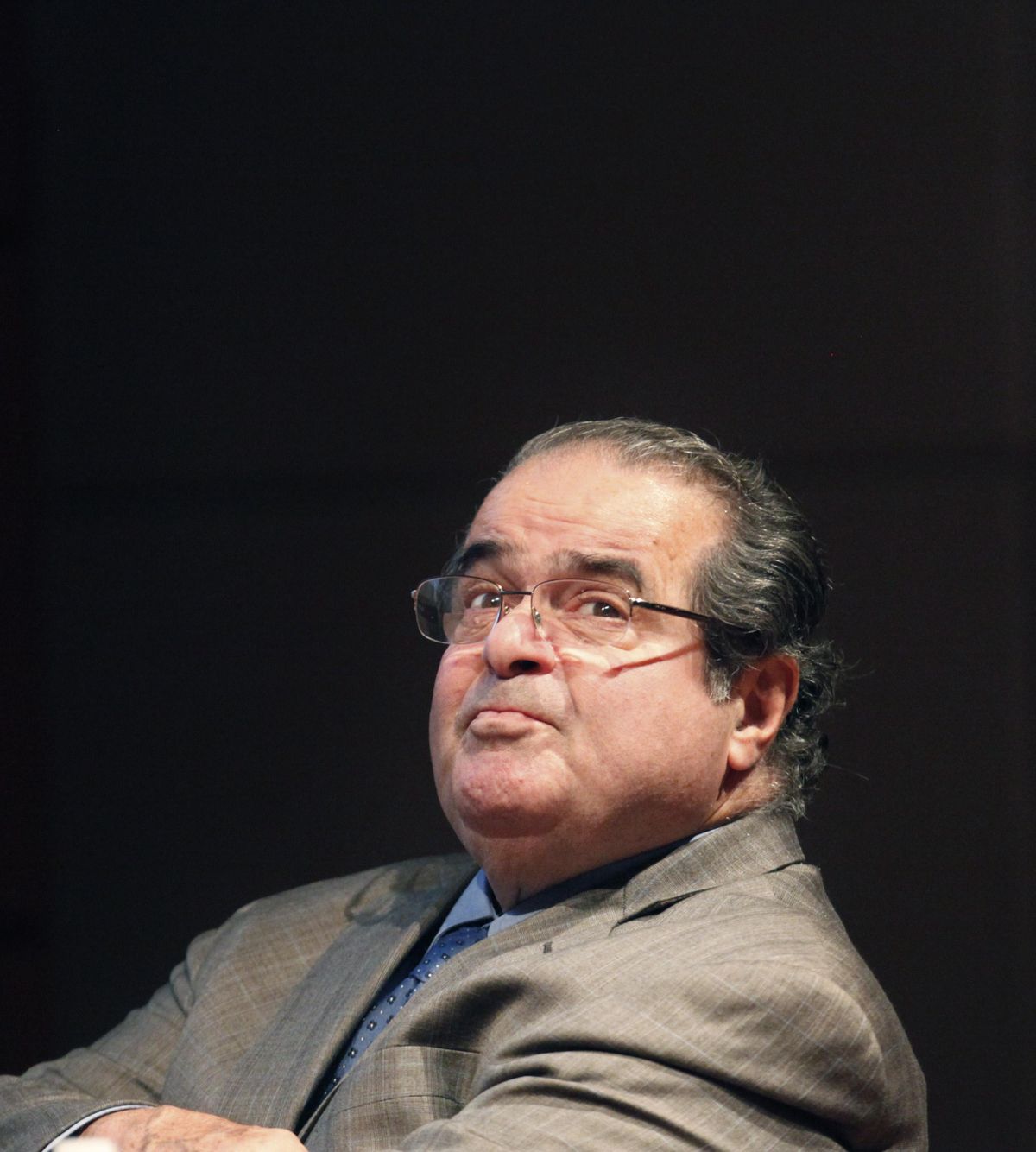 FILE - In this Oct. 18, 2011 file photo, U.S. Supreme Court justice Antonin Scalia looks into the balcony before addressing the Chicago-Kent College Law justice in Chicago. On Saturday, Feb. 13, 2016, the U.S. Marshals Service confirmed that Scalia has died at the age of 79. (Charles Rex Arbogast / Associated Press)