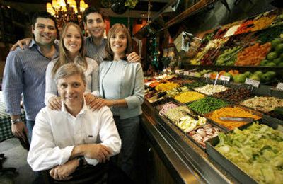 
Restaurant owner Richard Melman poses by the salad bar in his first restaurant, R.J. Grunt's, in Chicago's Lincoln Park neighborhood with his children, from left, R.J., Molly and Jerrod, and his wife Martha, right. 
 (Associated Press / The Spokesman-Review)