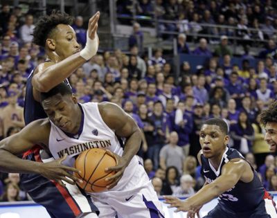 Washington’s Noah Dickerson tries to maneuver inside against Gonzaga’s Johnathan Williams as Zach Norvell Jr. looks on in the second half. (ELAINE THOMPSON / AP)