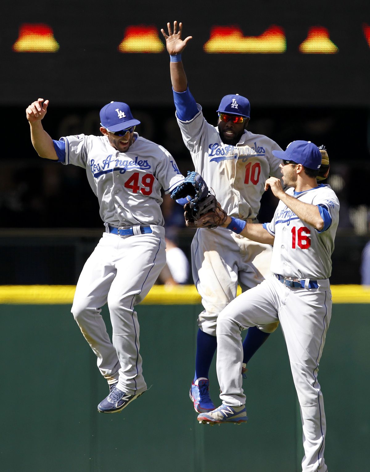 Dodgers outfielders Alex Castellanos (49), Tony Gwynn Jr. (10) and Andre Ethier celebrate a win. (Associated Press)
