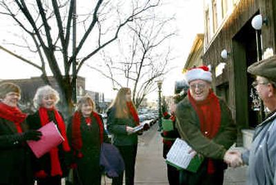 
Lowell Hayes, second from right, is greeted by a passer-by as a group of carolers sings Christmas songs Wednesday in downtown Coeur d 'Alene. Other carolers are, from left, Barb McGregor, Janet Taylor, Laura Augusta, Chelsea Stillman and Shelley Cornelius.Lowell Hayes, second from right, is greeted by a passer-by as a group of carolers sings Christmas songs Wednesday in downtown Coeur d 'Alene. Other carolers are, from left, Barb McGregor, Janet Taylor, Laura Augusta, Chelsea Stillman and Shelley Cornelius.
 (Kathy Plonka/Kathy Plonka/ / The Spokesman-Review)