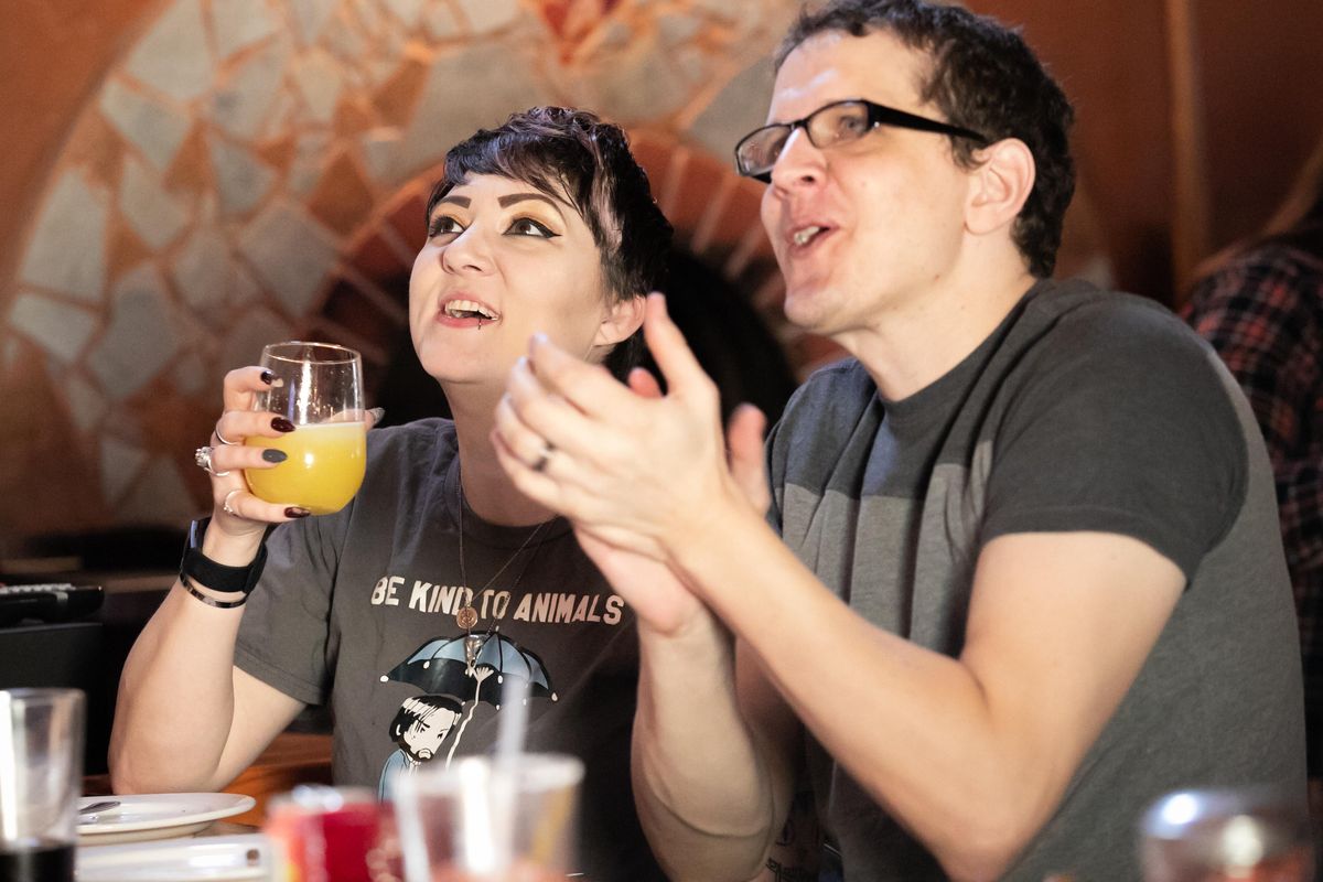 Meg and Aaron Determen cheer as they watch the 16th annual Puppy Bowl and see local puppy Filbert onscreen during a watch party at Embers By the Lake in Hauser, Idaho on Feb. 2, 2020. This year, Double J Dog Ranch contributed three disabled canines to the nationally televised programs: Lulu, for the Dog Bowl, and Filbert and Daphne for the Puppy Bowl, and received a portion of proceeds from every pizza purchased at Embers. (Libby Kamrowski / The Spokesman-Review)