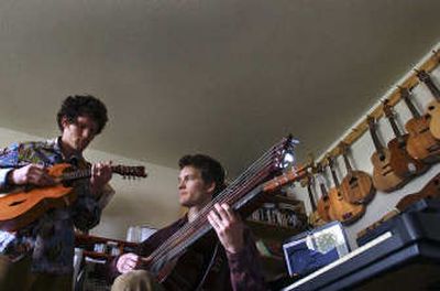 
Anthony Powell, left, and his brother David Powell, on harp guitar, of Athol, play in their band, Rex James. 
 (Kathy Plonka / The Spokesman-Review)