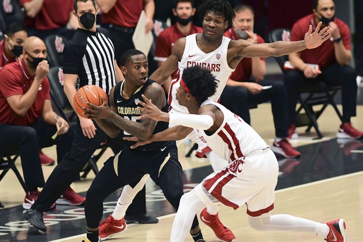 Washington State’s Efe Abogidi, right rear, and Noah Williams double-team Colorado guard McKinley Wright IV during the first half Saturday.  (Associated Press)