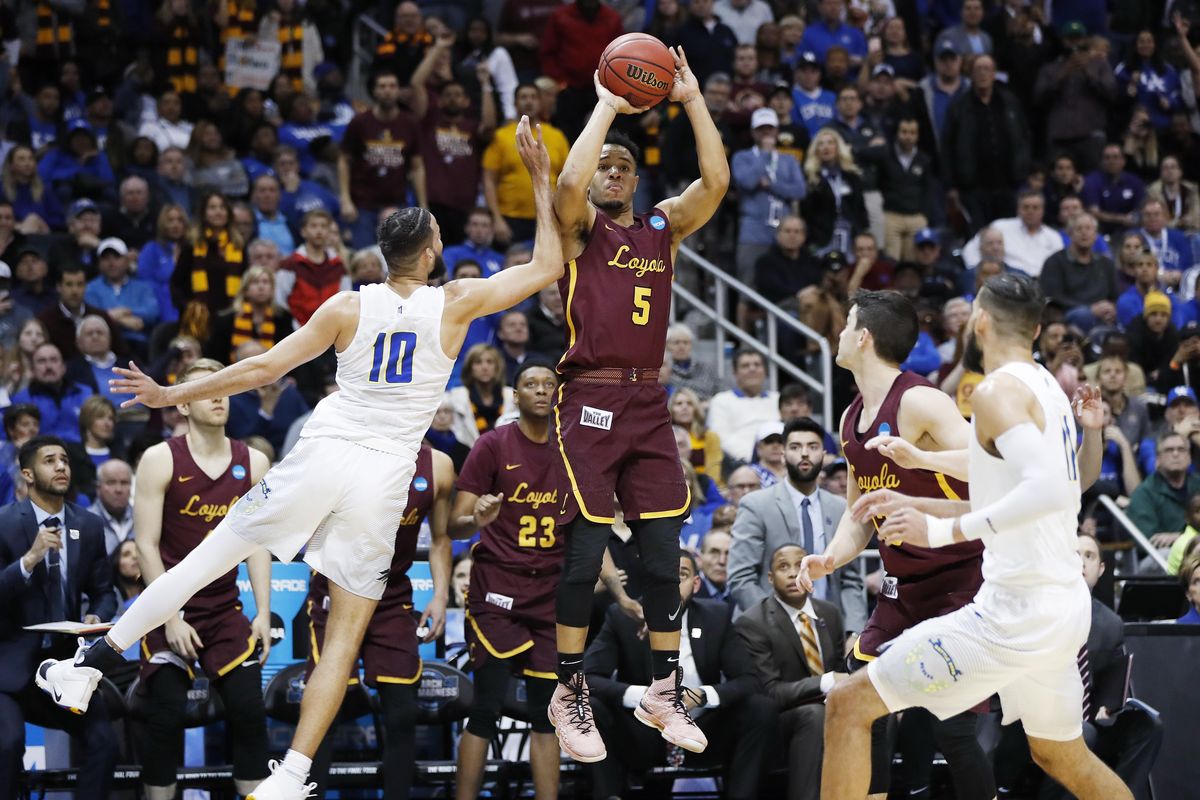 Loyola-Chicago guard Marques Townes (5) makes a three-point shot against Nevada forward Caleb Martin (10) late in the second half of a regional semifinal NCAA college basketball game, Thursday, March 22, 2018, in Atlanta. Loyola-Chicago won 69-68. (David Goldman / AP)