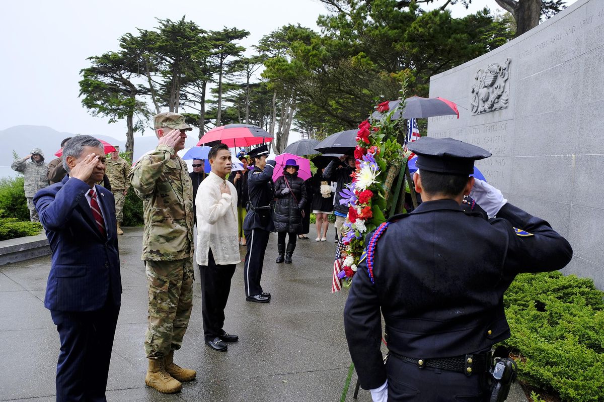 From left, Retired U.S. Major Gen. Antonio Taguba, Brig. Gen Brently White of the U.S. Army Reserves, and Philippine Consul General Henry Bensurto salute during a wreath laying ceremony for the 75th anniversary of the Bataan Death March at the Presidio