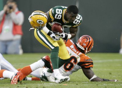 Green Bay’s James Jones loses his helmet but goes on to score.  (Associated Press / The Spokesman-Review)