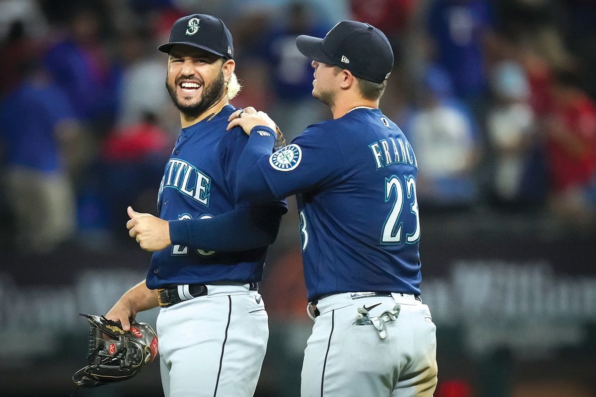 Seattle Mariners third baseman Eugenio Suarez (28) celebrates with third baseman Ty France after a victory over the Texas Rangers at Globe Life Field on Friday, June 3, 2022.The Mariners won the game 4-3 on a home run by Suarez in the ninth inning. 