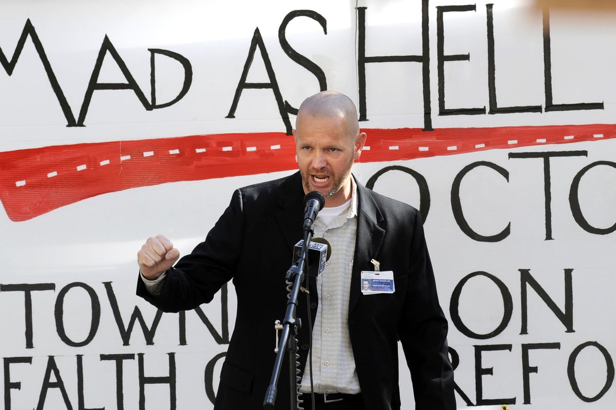 Dr. Jeremy Graham,  of Providence Sacred Heart Medical Center, rallies a crowd of supporters at the Mad as Hell Doctors rally  Wednesday at the  courthouse. (The Spokesman-Review)