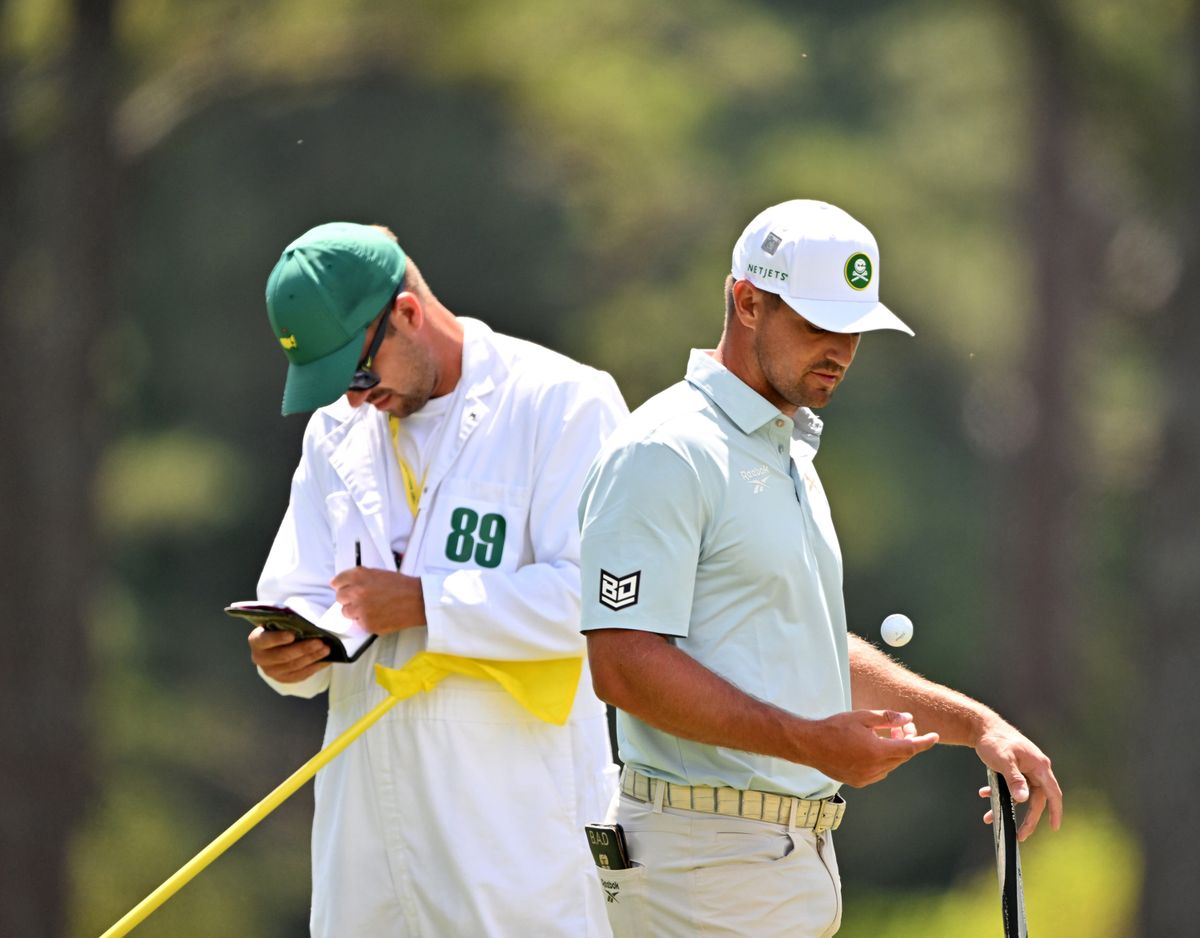 Bryson DeChambeau, right, and caddie Greg Bodine take a break Friday during the Masters in Augusta, Ga. (Tribune News Service)
