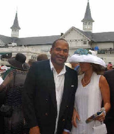O.J. Simpson makes his way through the crowd past the twin spires at Churchill Downs in Louisville, Ky., on May 1.
(Associated Press / The Spokesman-Review)