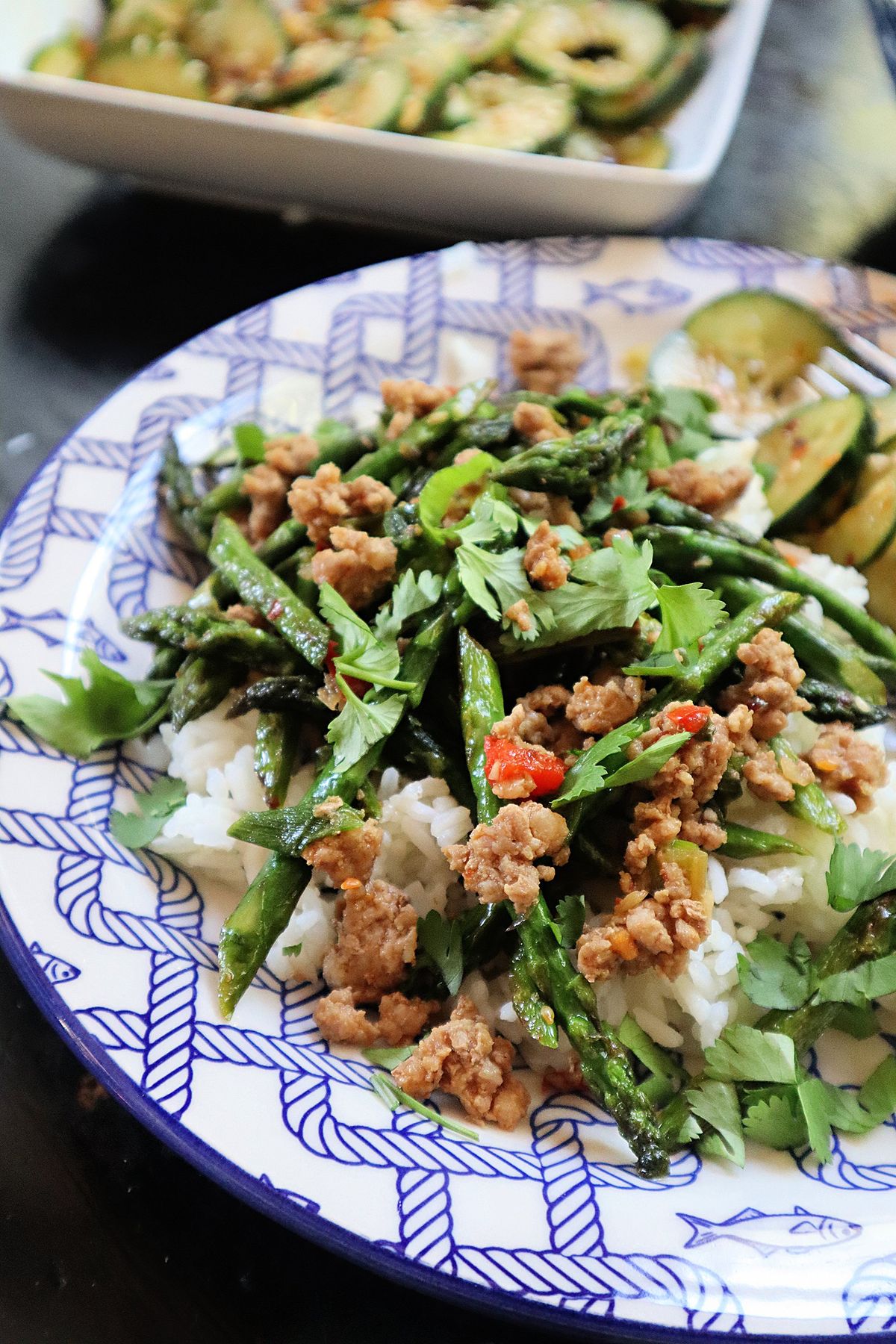 Thin stalks of spring asparagus are blistered, then tossed with ground pork, garlic, ginger and soy sauce.  (Gretchen McKay/Pittsburgh Post-Gazette)