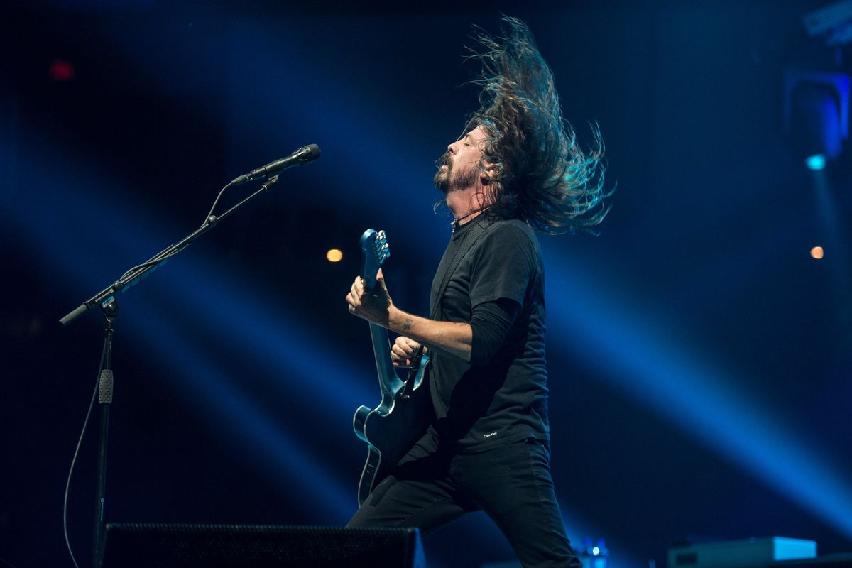 Foo Fighters’ front man Dave Grohl flips his hair during “All My Life” on Dec. 4, 2017, in the Spokane Arena. The band will return Aug. 4.  (DAN PELLE)