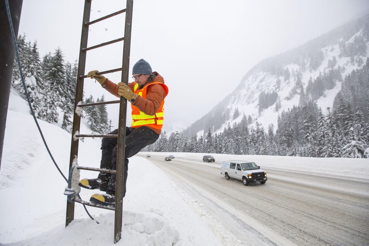 In this Monday, Jan. 9, 2017 photo, John Stimberis climbs up into an elevated platform at Snoqualmie Pass, Wash., just off the side of the road, which is used for avalanche control when conditions become hazardous. Two teens were killed in an avalanche over the weekend near Alpental ski area. (Bettina Hansen / AP)