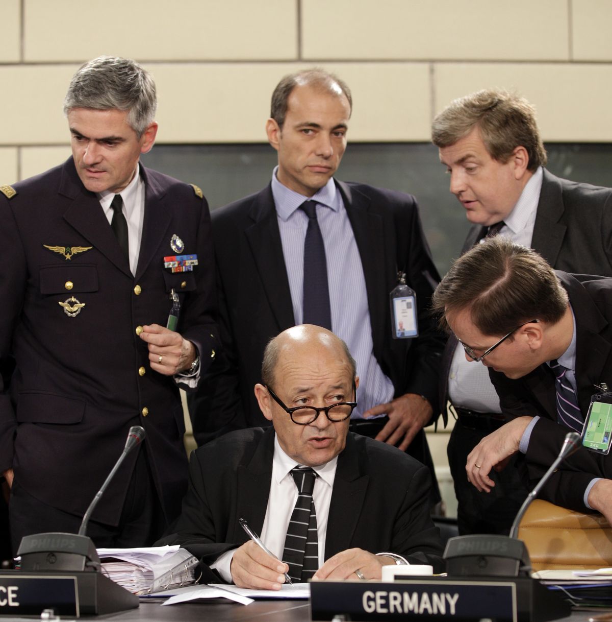 French Defense Minister Jean-Yves Le Drian, center, speaks with members of his delegation during a meeting of NATO Defense Ministers at NATO headquarters in Brussels on Tuesday, Oct. 9, 2012. NATO defense leaders gathering for a two-day meeting in Brussels, are committed to the war in Afghanistan, according to U.S. and alliance officials, but there are growing signs that the Afghan political and military hostilities against the coalition are starting to wear on the coalition. (Virginia Mayo / Associated Press)