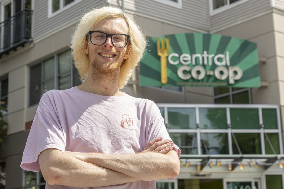Tyler Heller, assistant manager at the Central Co-op in the Capitol Hill neighborhood of Seattle, poses for a portrait at his workplace on July 22. He’s among the workers benefiting from Washington’s new law removing taxes on overtime pay. (Akash Pamarthy/The Seattle Times/TNS)