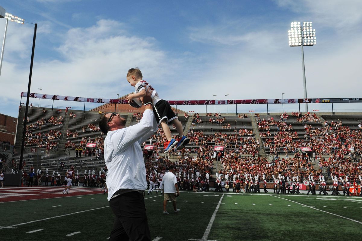 Former WSU quarterback Ryan Leaf raises his son, McGyver Fitzgerald Leaf to cheers from WSU fans as he is inducted into Washington StateÕs Hall of Fame during the second half of a college football game on Saturday, September 7, 2019, at Martin Stadium in Pullman, Wash. (Tyler Tjomsland / The Spokesman-Review)