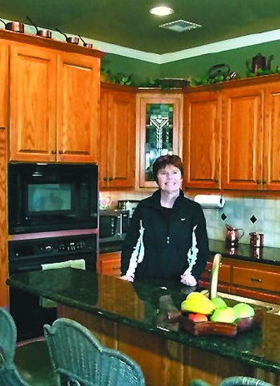 
Nancy Atwater stands in the kitchen of her home outside Sperry, Okla. She and her husband Mike participate in the home exchange vacation program through HomeLink International.
 (Associated Press / The Spokesman-Review)