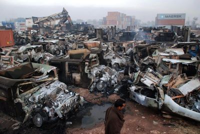 Rows of destroyed Humvees and military trucks are seen at the Portward Logistic Terminal in Peshawar, Pakistan, on Sunday.  (Associated Press / The Spokesman-Review)