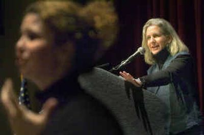 
Terry Tempest Williams speaks at Spokane Community College Monday as an interpreter signs in the foreground for the hearing impaired. 
 (Christopher Anderson/ / The Spokesman-Review)