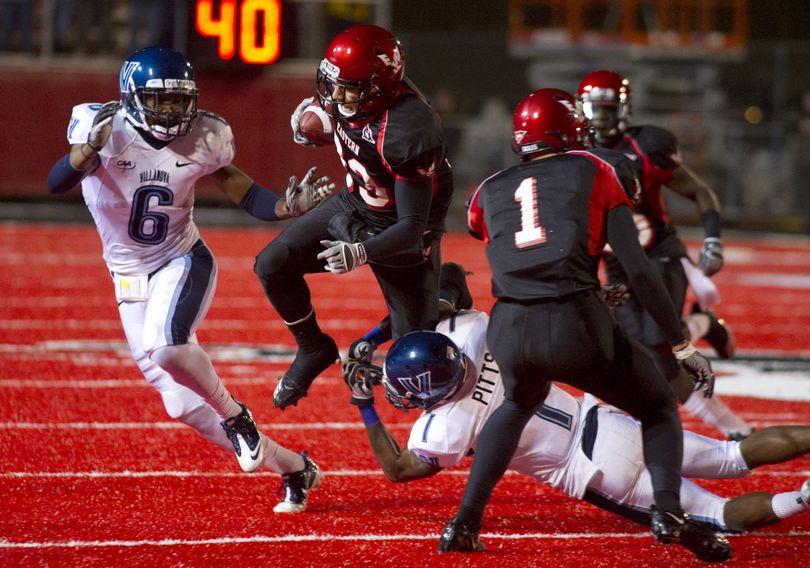 As Villanova University���s Ronnie Akins (6) closes in, Eastern Washington University wide receiver Tyler Hart (33) tries to break a tackle from Villanova's James Pitts (1) Friday, Dec. 17, 2010 during the NCAA Football Championship Subdivision Playoffs on Roos Field at the EWU campus in Cheney, Wash. (AP/Colin Mulvany) (Colin Mulvany / The Spokesman-Review)