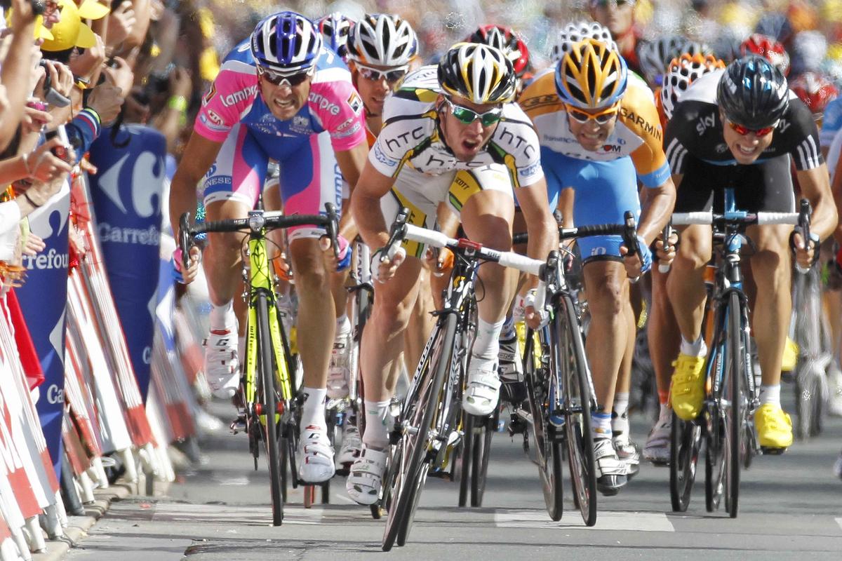Great Britain’s Mark Cavendish, center, won his 14th career Tour de France stage in a bunch sprint on Friday. (Associated Press)