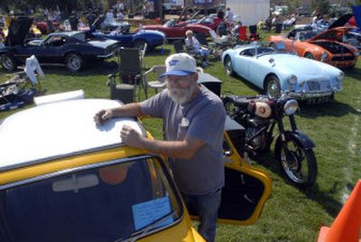 Pete Charbonneau stands by his 1970 Subaru,  which has a two-cylinder, two-stroke motor, on Saturday at Silverwood Theme Park's annual car show, the Coaster Classic. Behind him is his 1948 BSA motorcycle. 
 (Photos by JESSE TINSLEY / The Spokesman-Review)