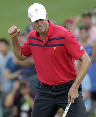 Matt Kuchar, of the United States, makes a birdie putt on the 18th hole. (Associated Press)