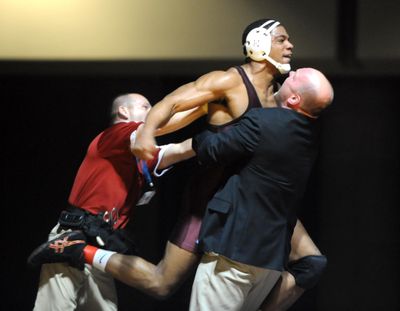 North Idaho College’s Jamelle Jones jumps into the arms of his coach, Pat Whitcomb, after pinning Walker Clarke of Labette Community College in the 197-pound class Saturday, Feb. 26, 2011, at the Spokane Convention Center. (Jesse Tinsley / The Spokesman-Review)