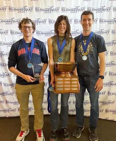From left to right, Gonzaga University employees Richard Keroack, Jackie Van Allen and Chris Fink pose with their Bloomsday Corporate Cup first place trophies and medals at a Bloomsday banquet May 21 at the Spokane Club. (COURTESY)