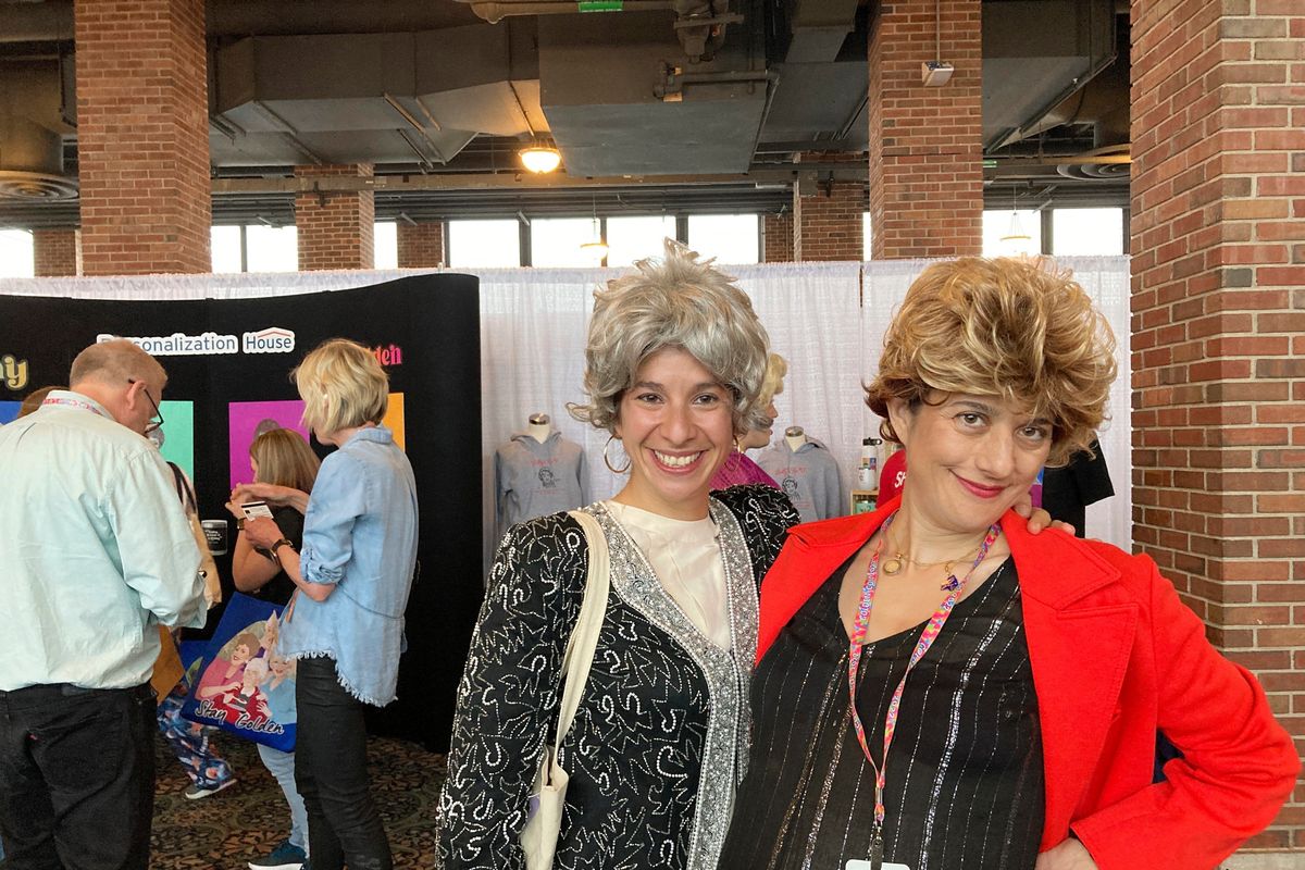 Hillary Wasicek and Melissa Gluck, sisters, pose as the characters Dorothy and Blanche at a "Golden Girls" fan convention in Chicago, Friday, April 22, 2022. Golden-Con, which lasts thru Sunday, is giving those who adored the NBC sitcom a chance to mingle, see panels and buy merchandise. The show, which ran from 1985-1992, starred Bea Arthur, Rue McClanahan, Estelle Getty and Betty White—who died at age 99 in December.  (Terry Tang)