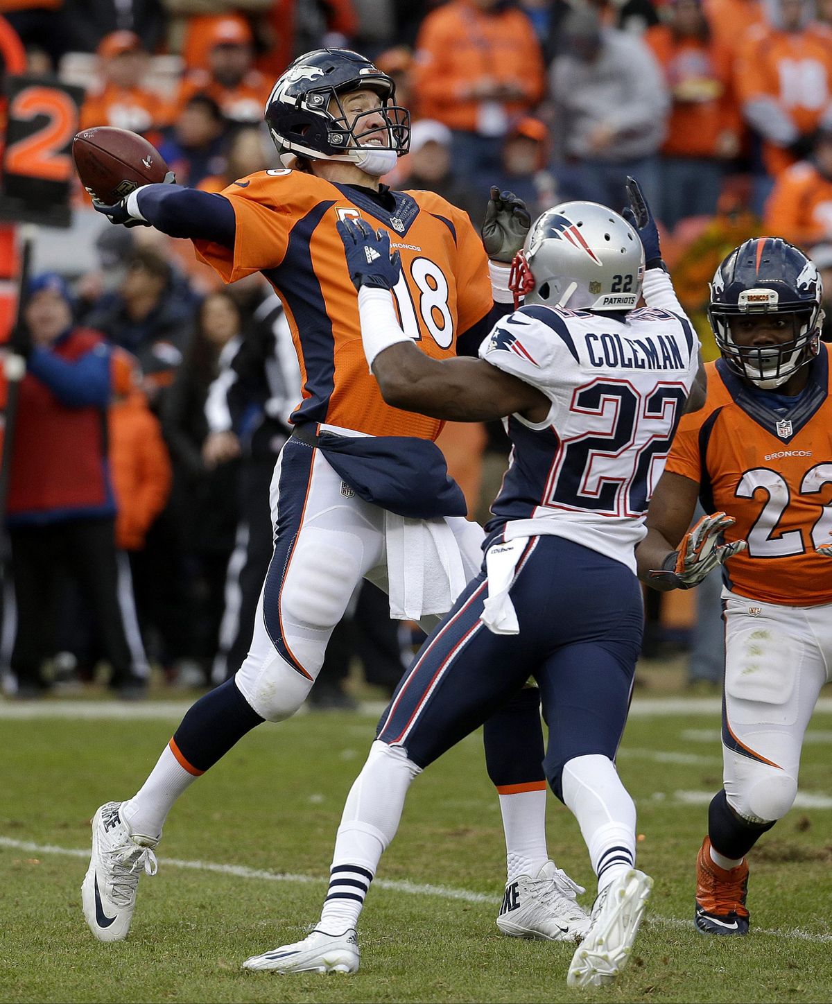 Denver Broncos quarterback Peyton Manning passes while being defended rushed by New England Patriots cornerback Justin Coleman (22) during the second half of the NFL football AFC Championship game between the Denver Broncos and the New England Patriots, Sunday, Jan. 24, 2016, in Denver. (AP / AP)