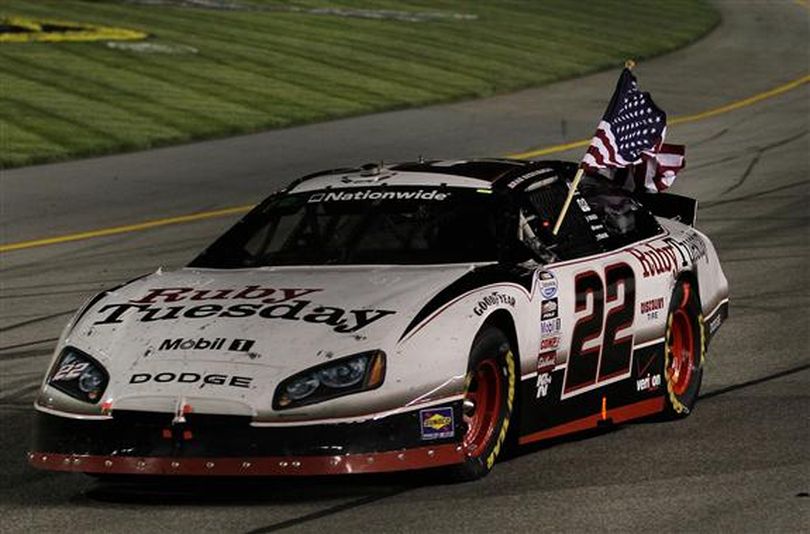 ather than a burnout, Brad Keselowski celebrates his second win of the season hoisting an American flag during a victory lap at Richmond International Raceway. (Photo courtesy of Al Bello/Getty Images)