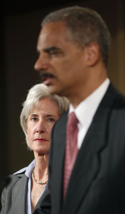 Attorney General Eric Holder, right, and Health and Human Services Secretary Kathleen Sebelius, at a news conference at the Justice Department on Wednesday.  (Associated Press / The Spokesman-Review)