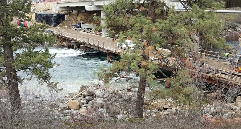 Sullivan Road bridge reconstruction -- workers maneuver on a temporary bridge on the downstream side of the main bridge in this Feb. 14, 2015, view with the river running at 20,000 cfs. (Tanner Grant)