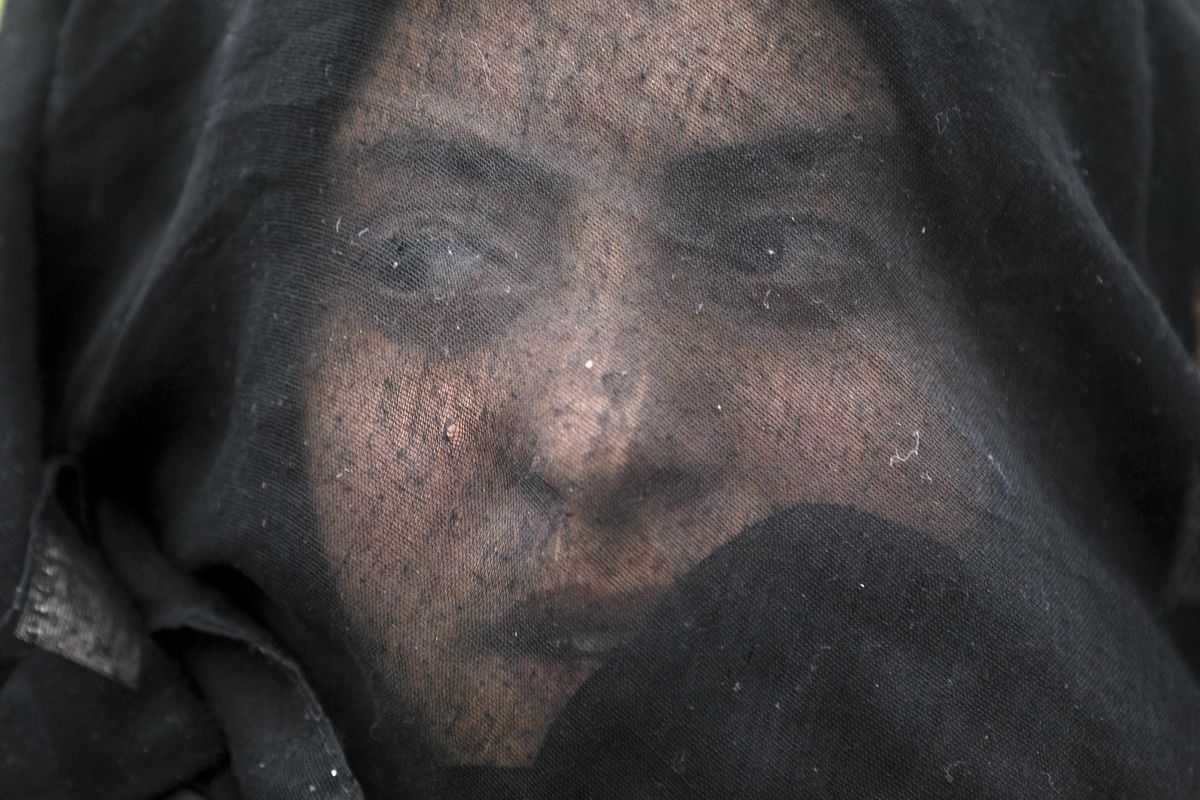 A woman shouts slogans during a protest by migrants demanding the opening of the border Sunday between Greece and Macedonia at the northern Greek border station of Idomeni. (Vadim Ghirda / Associated Press)