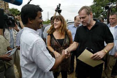 
Norway's Foreign Minister Jan Petersen, right, shakes hand with Thamilselvam, a political leader of the Tamil Tiger rebels. 
 (Associated Press / The Spokesman-Review)