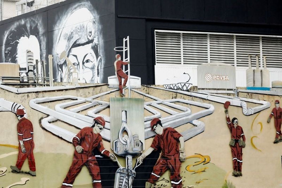 A mural depicting oil workers of Venezuelan state oil company PDVSA is pictured near the company