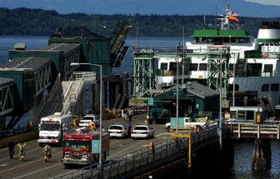 
Police and fire department personnel search the Edmonds- Kingston ferry for hazardous materials after finding a threatening note aboard the vessel Monday in Edmonds, Wash. 
 (Associated Press / The Spokesman-Review)